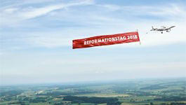 Flugzeug mit Banner Reformationstag